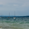 Several boats are in the water and some people are on them.
